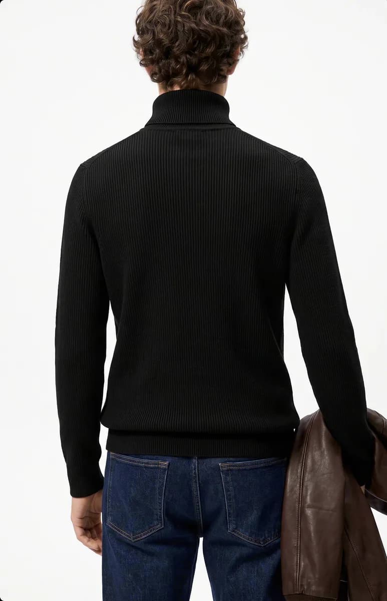 Model in a black turtleneck, back view