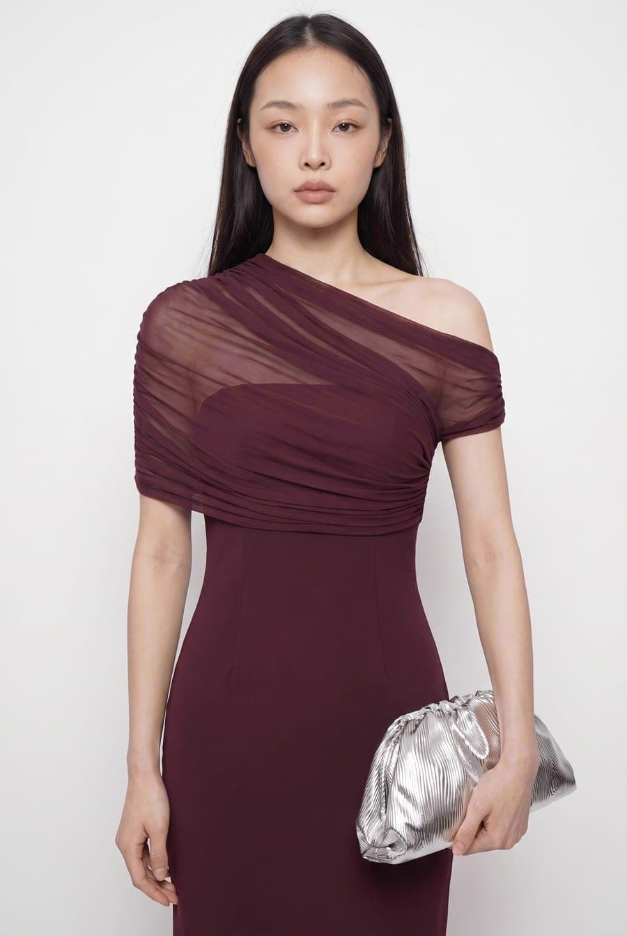 Model in a burgundy one-shoulder dress, front view